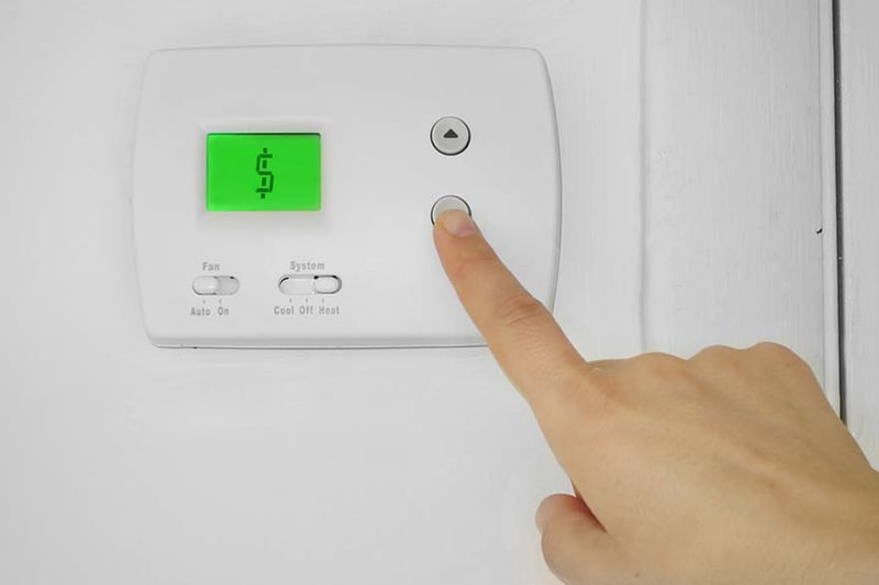 Blog Title: 5 Ways to Save Money on Your AC & Summer Energy Bill Photo: Thermostat with saving money sign