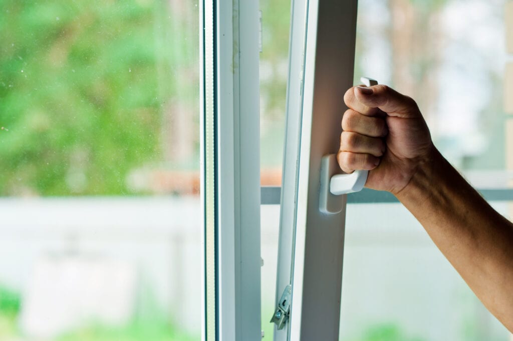 Blog Title: Why Is Indoor Air Quality (IAQ) Important? Photo: Person opens the plastic window