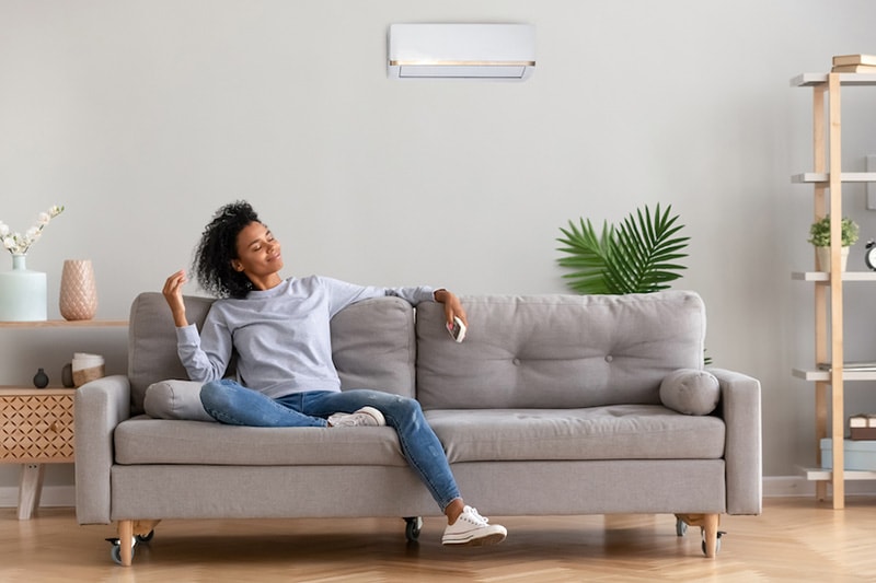 Young woman relaxing on a couch, What Accessories Can Help With My Indoor Air Quality?