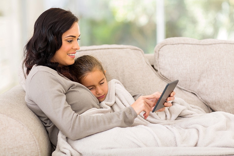 Mother and daughter reading from a tablet, The Basics of Winter Indoor Air Quality | Bremerton, WA | Dana's Heating